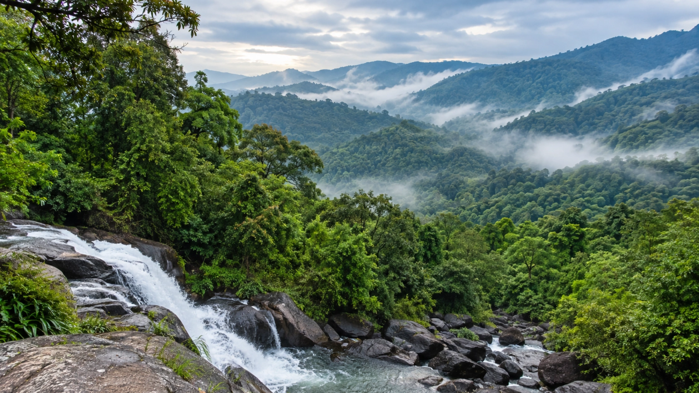 Misty rainforest hills and waterfall in Sakleshpur.